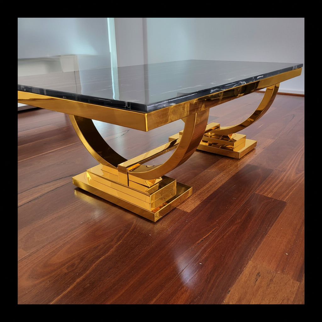 Coffee table with a marble top and a stainless steel metal frame on a wooden floor