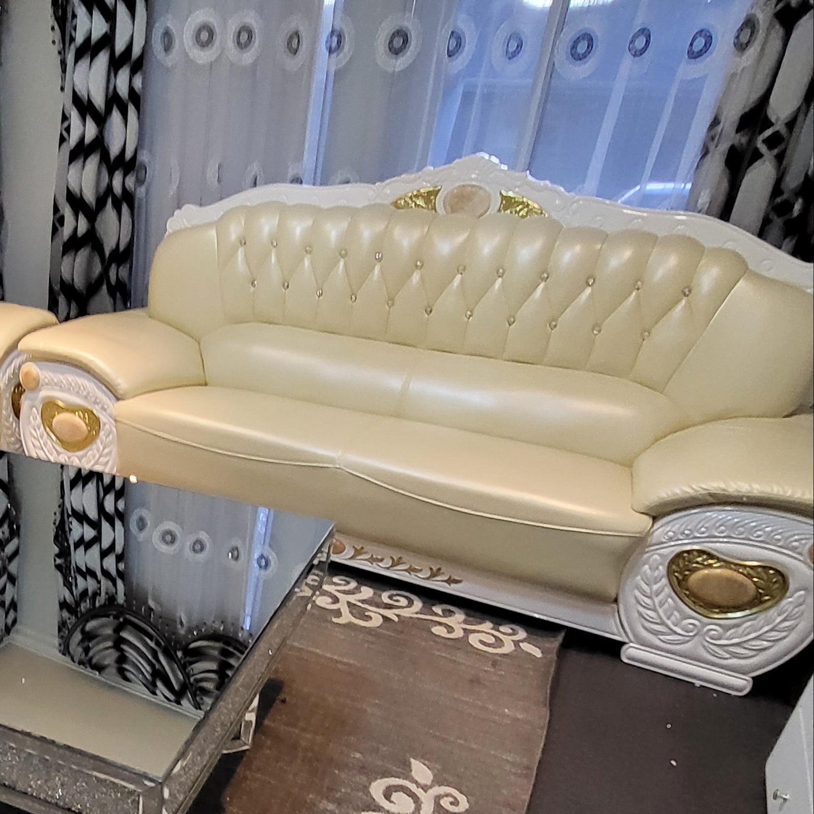 Decorative white phone on a wooden surface with intricate carvings