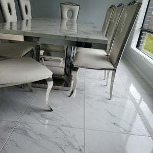 Luxurious and Stylish Elegant Marble Dining table with Circle White Leather Dining Room Chairs in Silver Stainless Steel Frame.