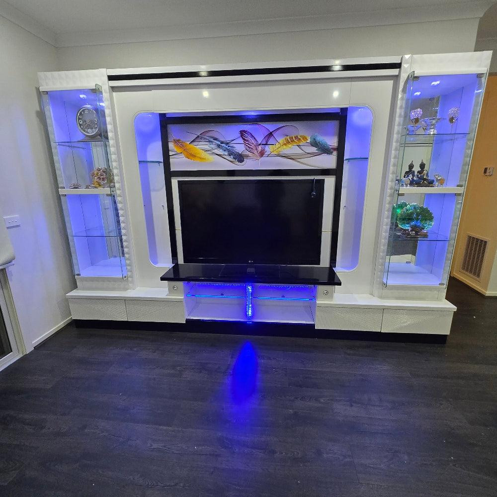 Modern entertainment console with LED lighting in a room.