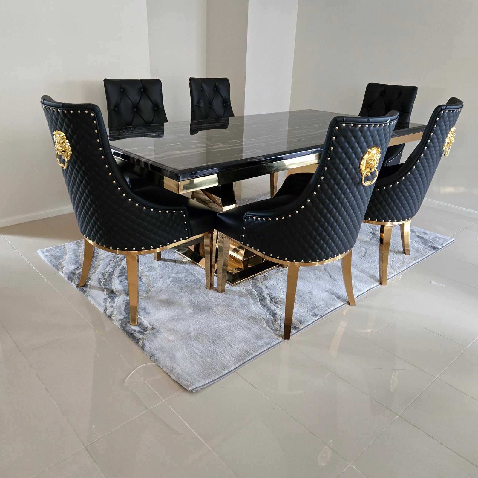 Black high-heeled shoes with gold accents on a marble staircase