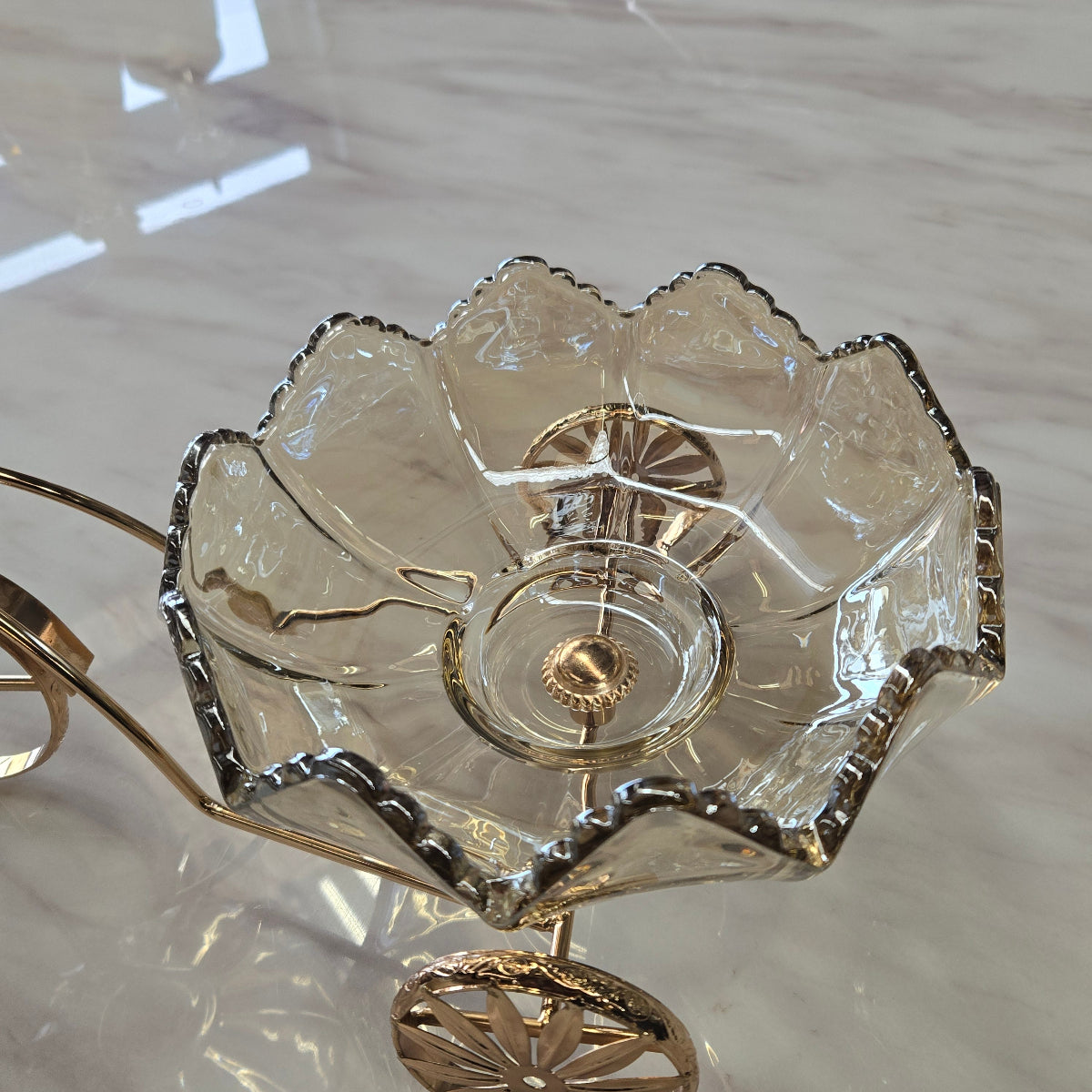 Decorative glass item with gold accents on a marble surface