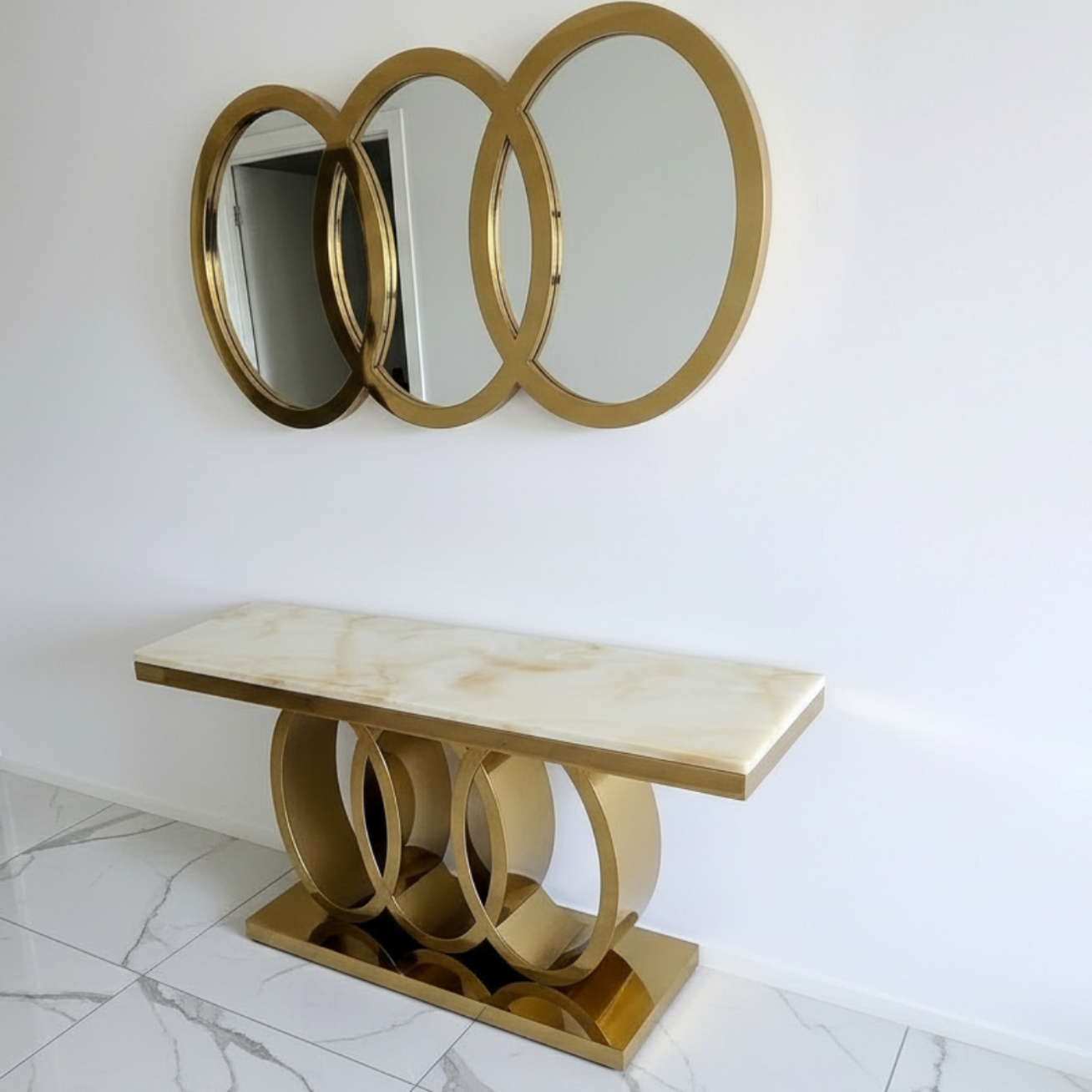Gold console table with marble top against a white wall
