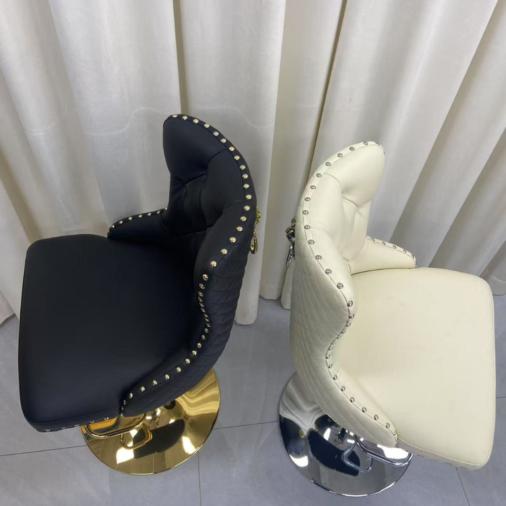 Black and white bar stools with gold and silver bases against a white curtain background