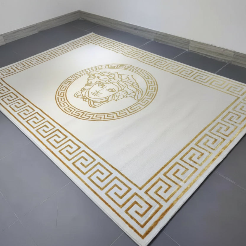 White rug with gold geometric patterns and a central emblem on a gray floor.