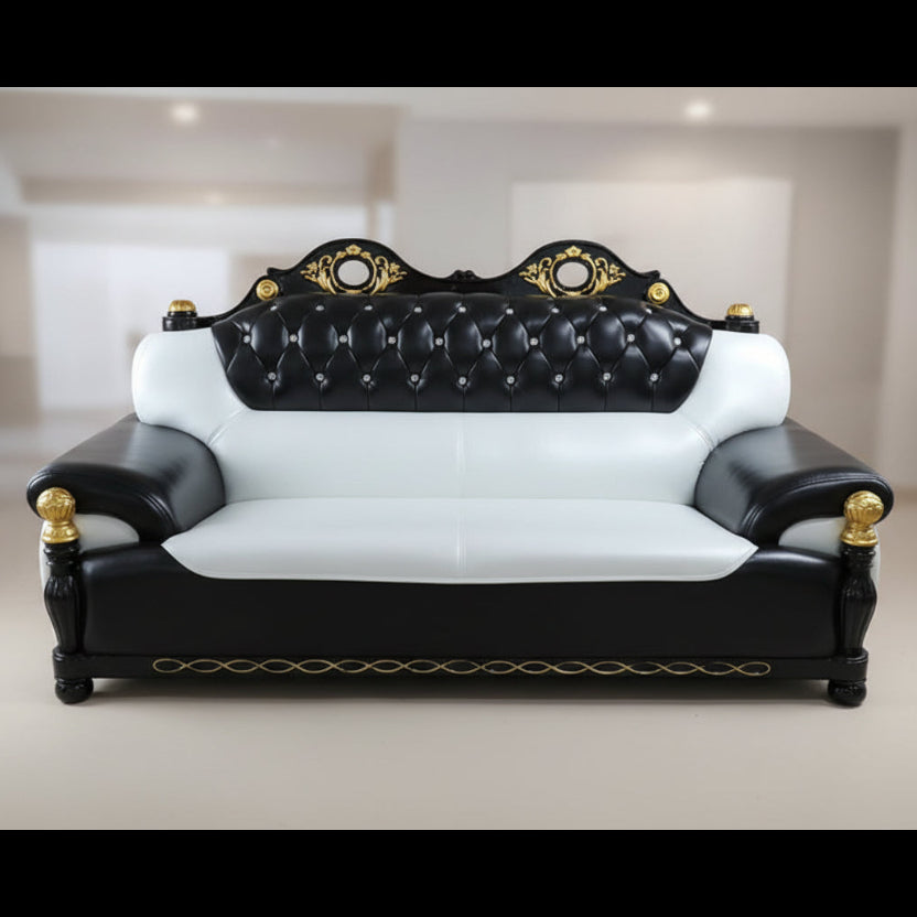 Black and white sofa set with gold accents in a room setting.