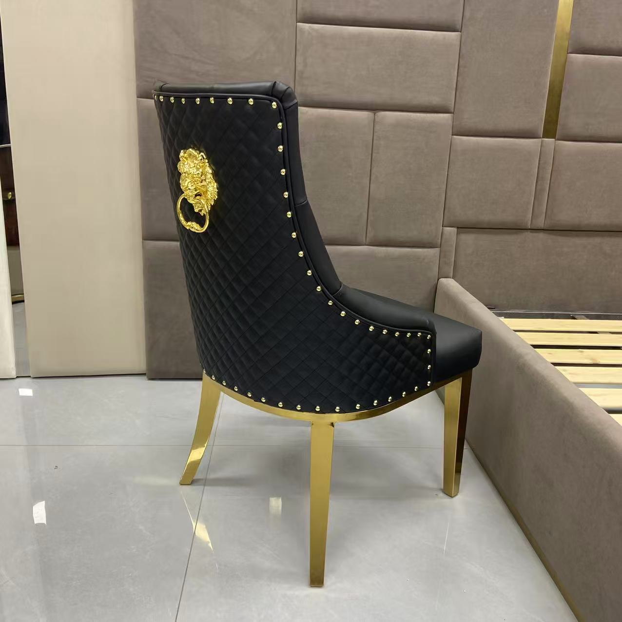 Black chair with gold accents and lion emblem in a room setting