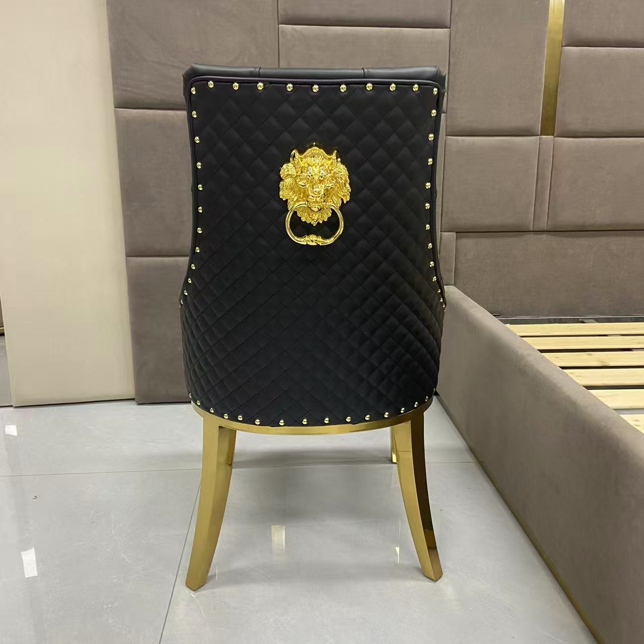 Black chair with gold lion emblem and studding in a room setting