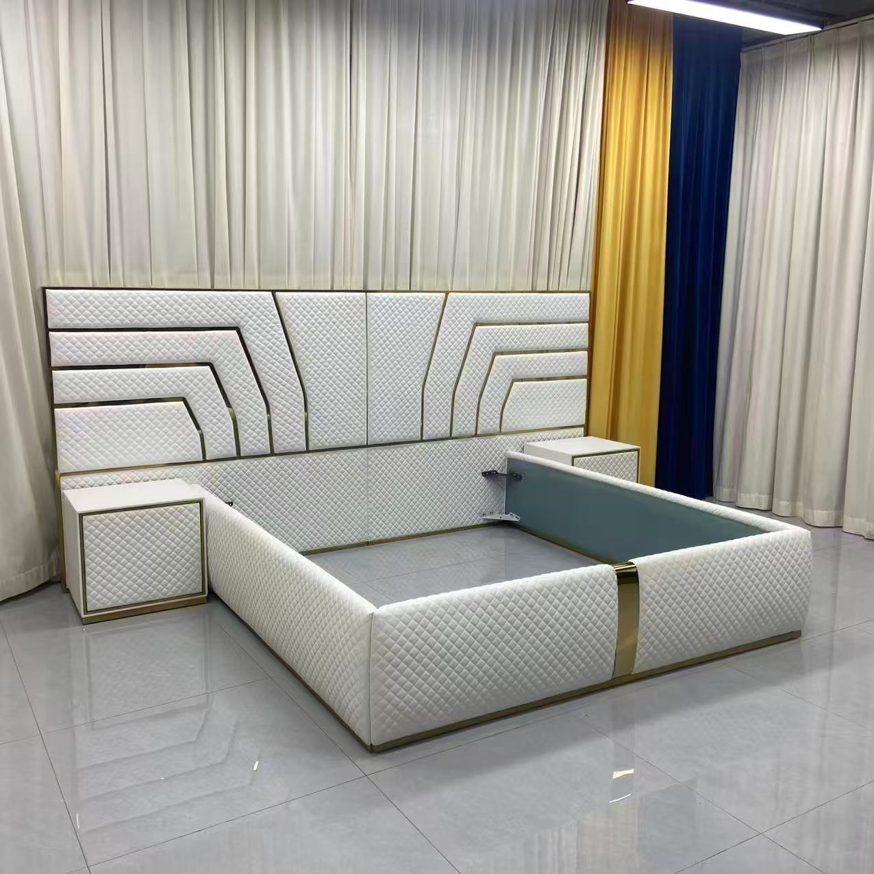 Modern white bed with geometric design in a room with curtains and tiled floor.