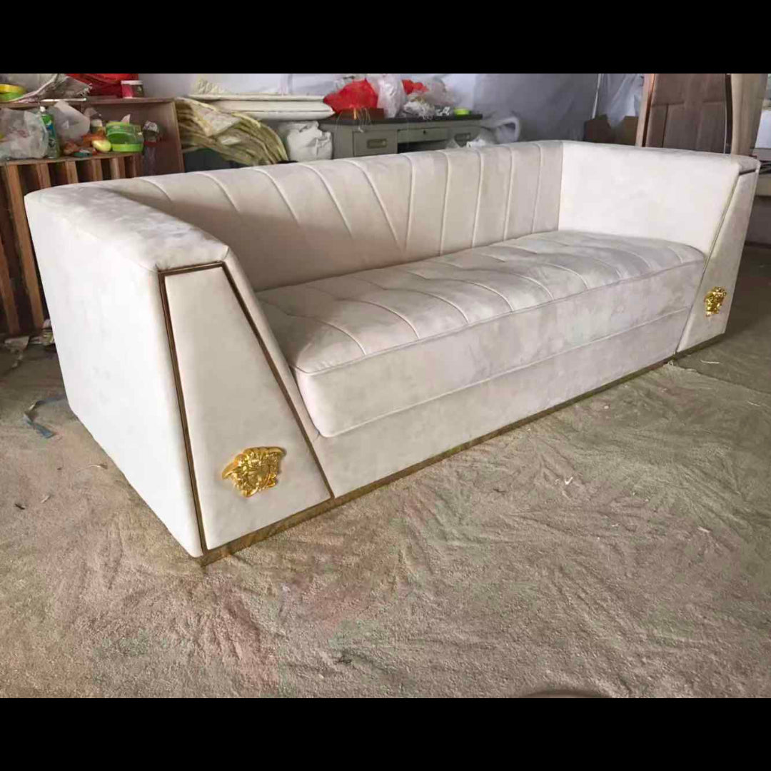 Beige sofa with gold accents in a room setting