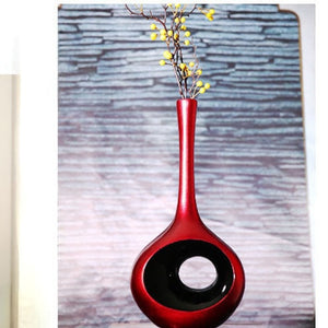 The perfect finishing touch to your home decor is the red stylish and modern exquisite right-sized ceramic sculptures with a black hole
