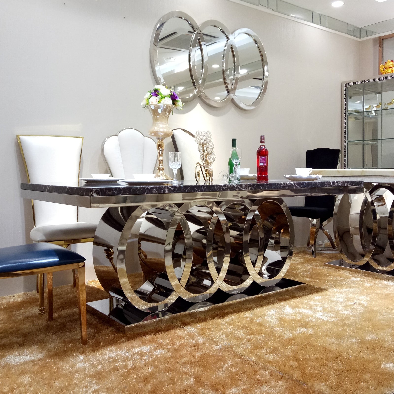 RBM Classic Home Online Furniture Store / Shop With Cheap / Discounted Prices. Luxurious and Stylish Elegant Marble Dining table with Gold Modern Black Velvet Dining Room Chairs in Stainless Steel Frame.