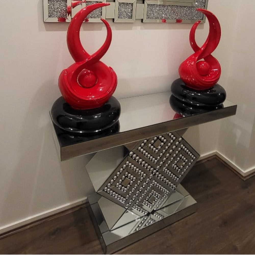 Decorative glass table with geometric design on a reflective surface