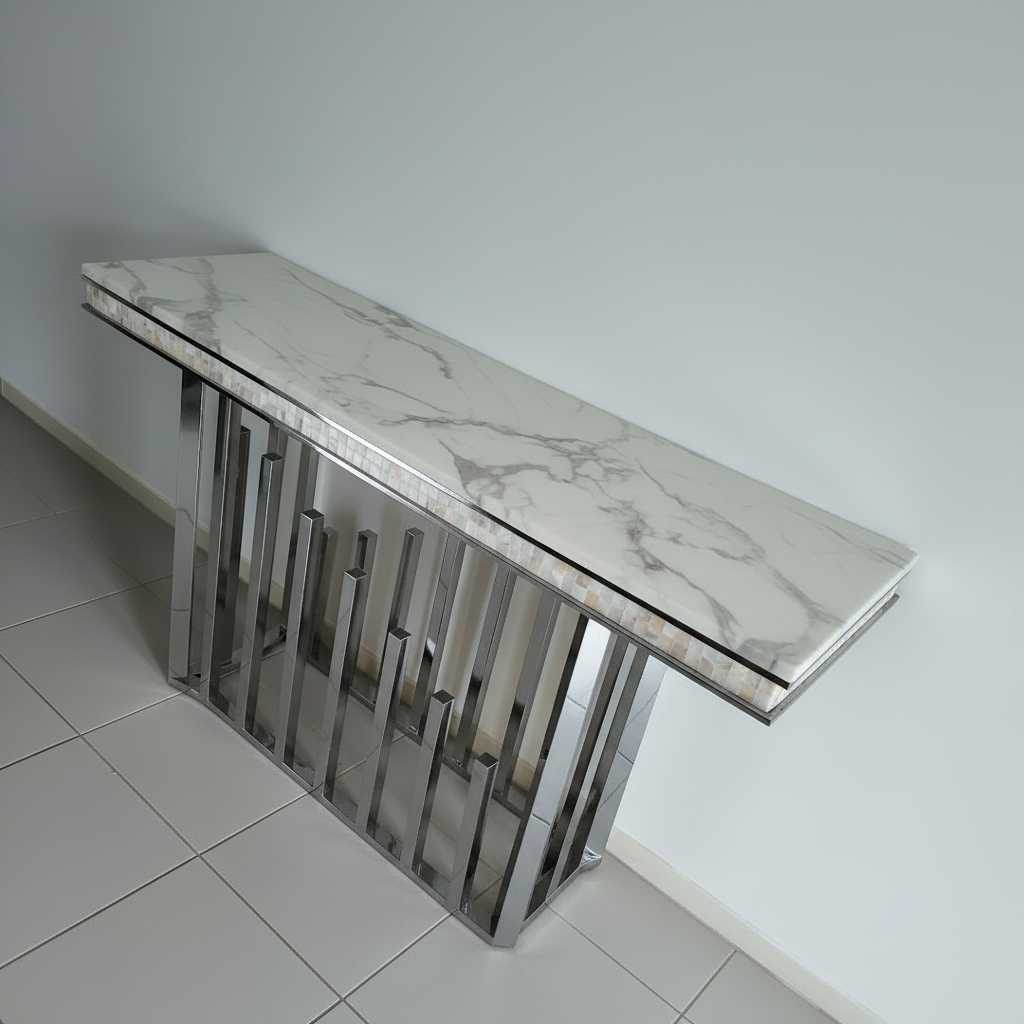A modern console table with a white and gray marble-patterned top and a polished silver metal frame with vertical bars.