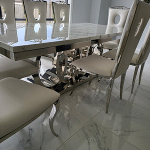 Luxurious and Stylish Elegant Audi Marble Dining table with Circle White Leather Dining Room Chairs in Silver Stainless Steel Frame.