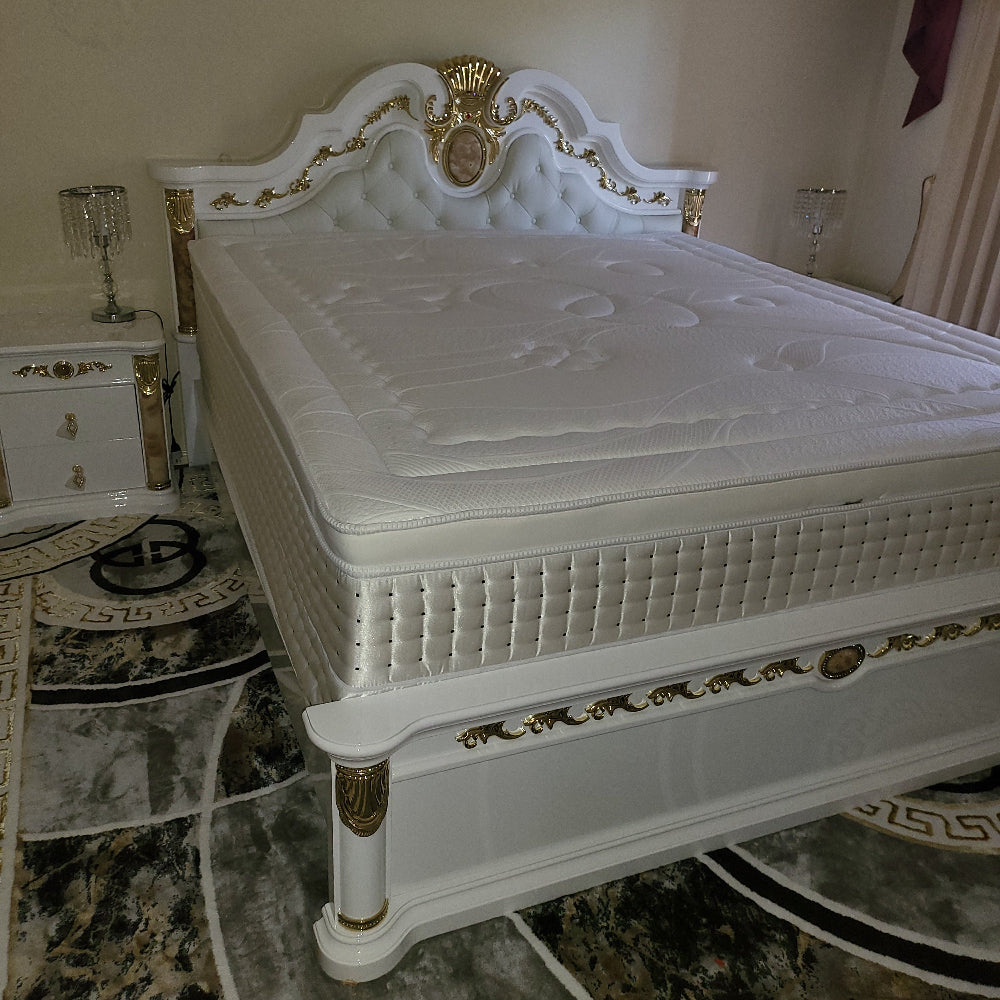White decorative cabinet with gold accents on a marble floor