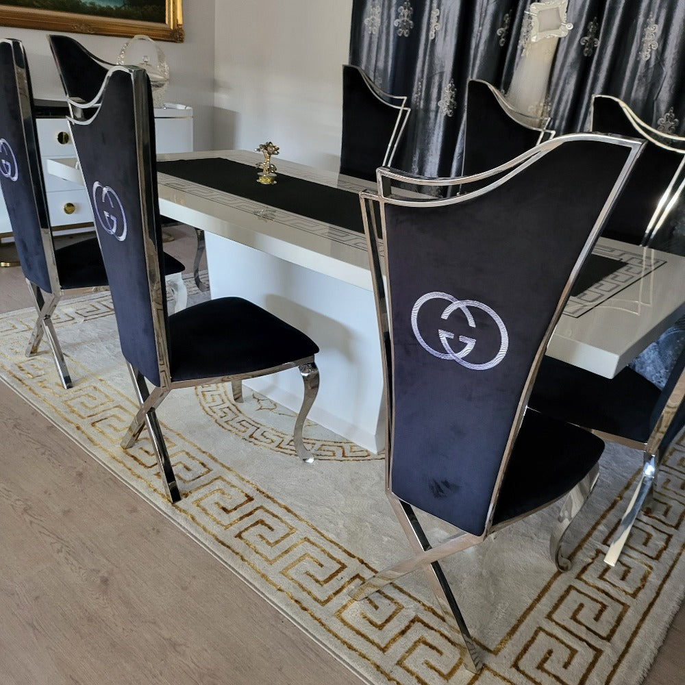 Classy Marble Dining Table With Modern Black Velvet Dining Room Chairs in Silver Stainless Steel Frame