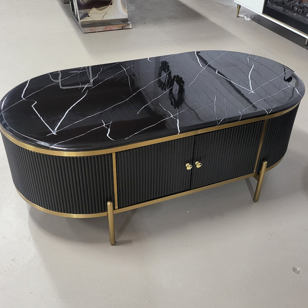 A black modern marble top coffee table with stainless steel frame and gold accents, featuring four drawers.