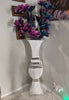 White bow tie with decorative elements on a reflective surface