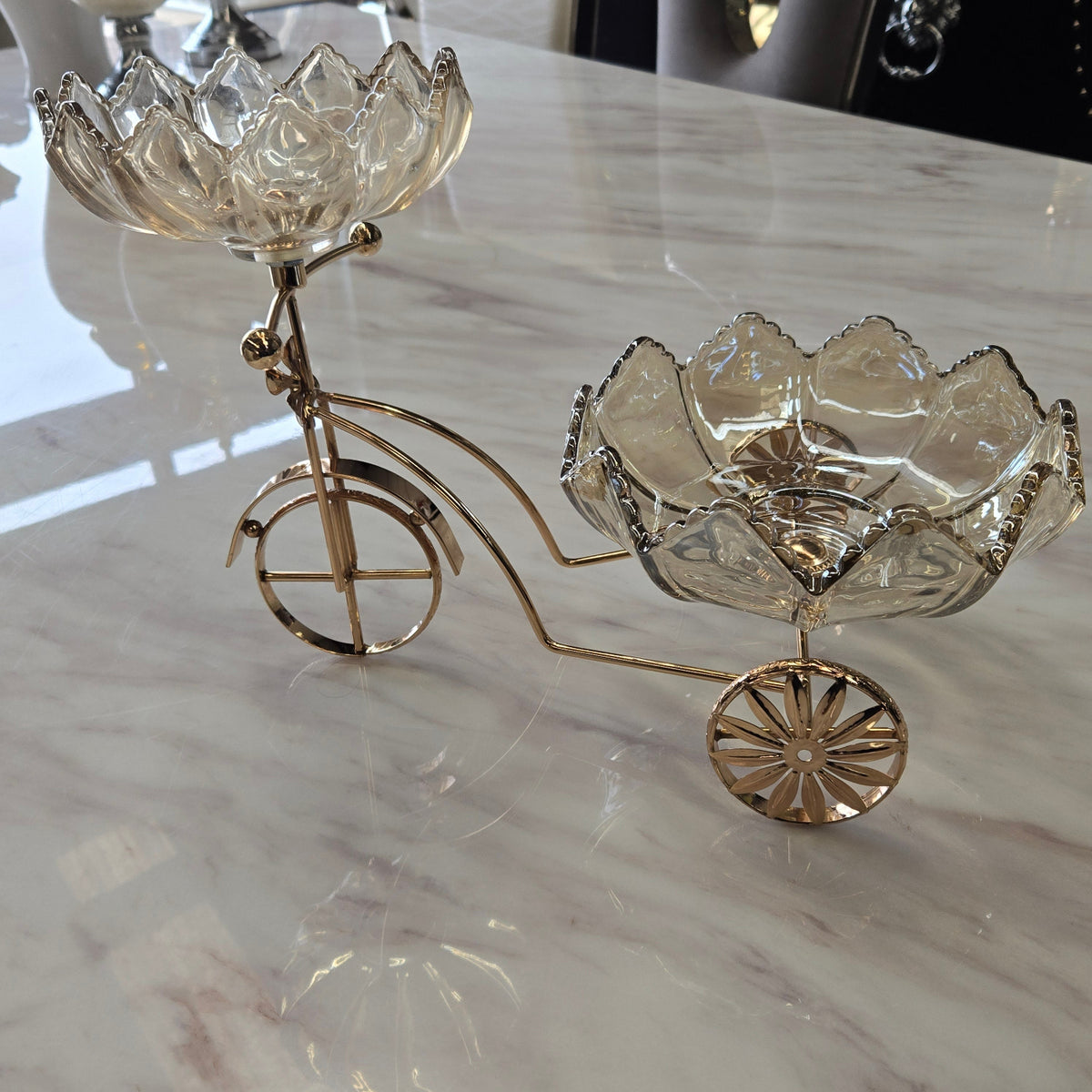 Decorative wall piece resembling a vintage bicycle with floral details on a marble background