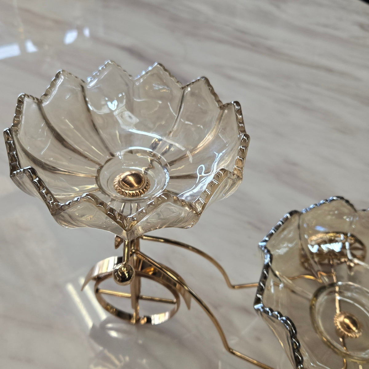 Decorative bicycle shaped serviving piece with floral designs on a marble surface