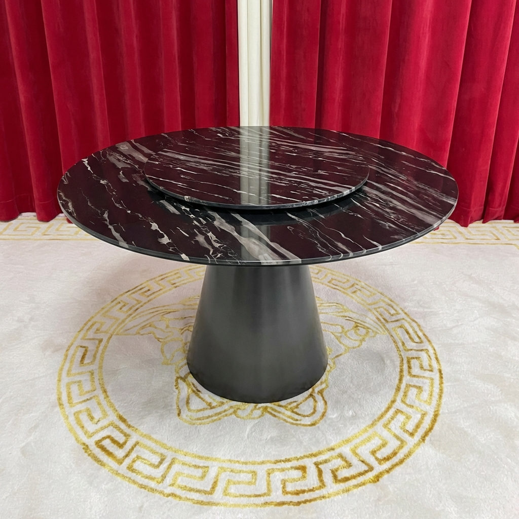 Marble-top table with a dark base on a decorative rug with red curtains in the background