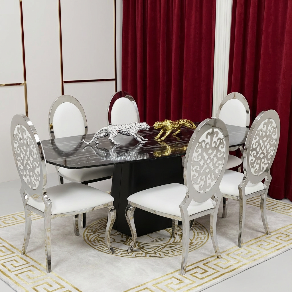 Dining room with a marble table and ornate chairs in front of red curtains.