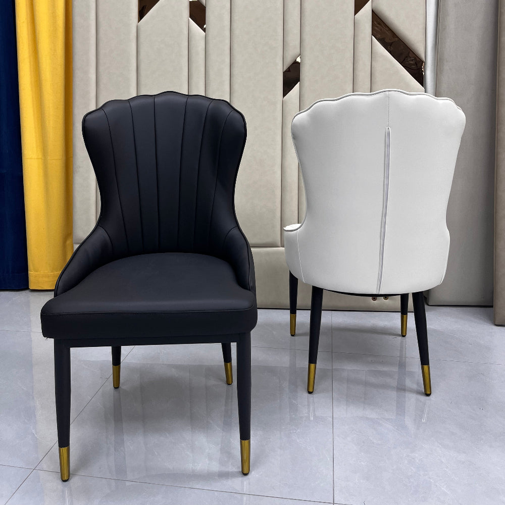Two chairs, one white and one black, on a geometric-patterned floor.