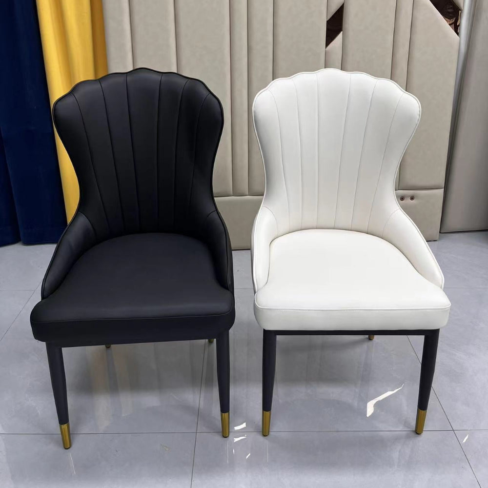 Black and white chairs with wooden and gold trim legs on a grey floor.