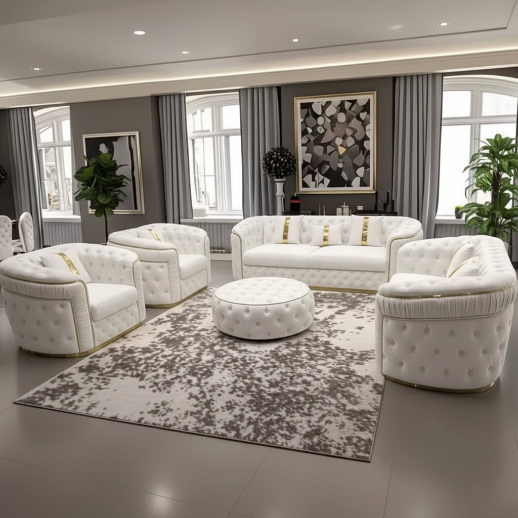 A luxury white tufted leather sofa set arranged in a modern living room. The set includes a three-seater sofa, two armchairs, a round ottoman, and a matching area rug with a gray and white abstract pattern.