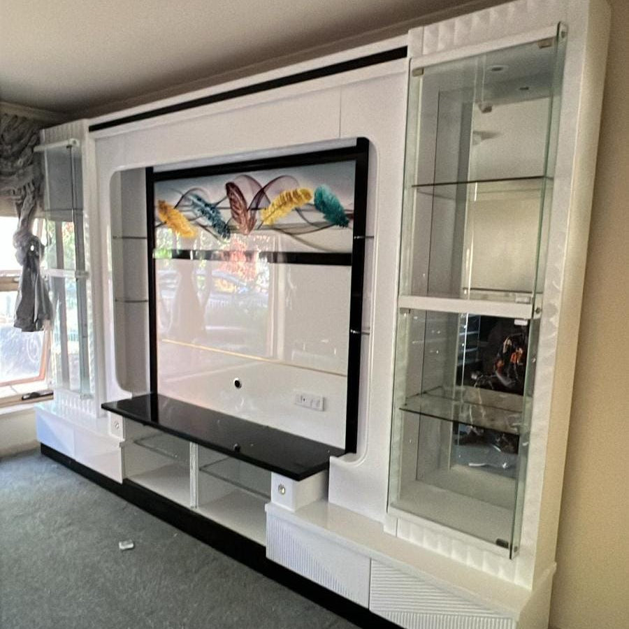 Modern living room with a white entertainment console and TV.