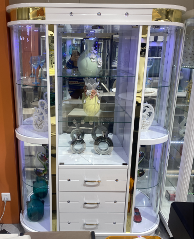 Glass display cabinet with decorative items inside