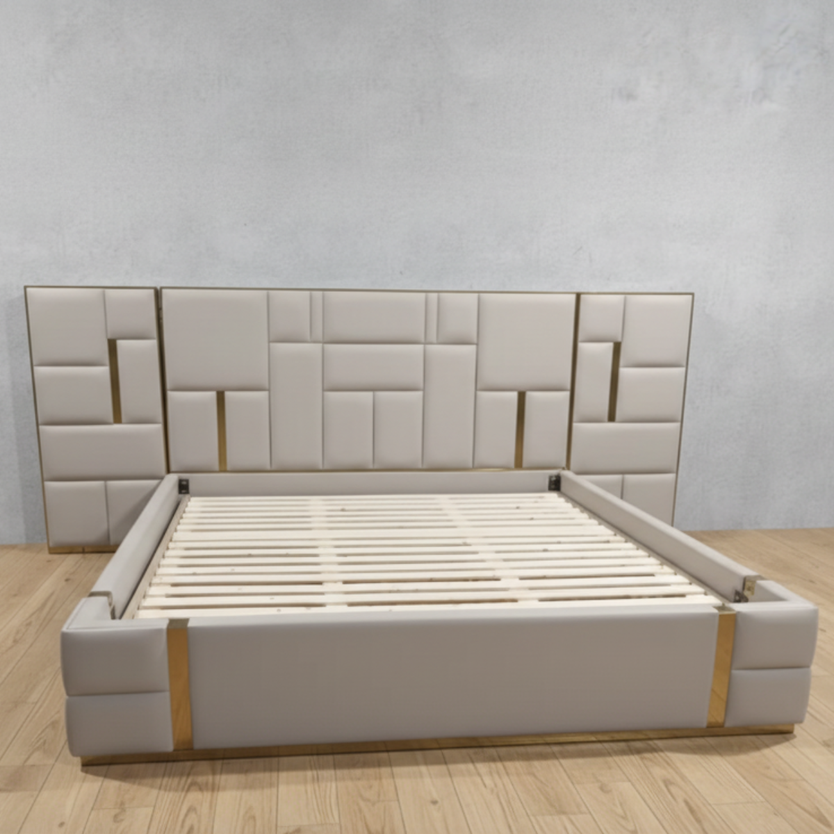 Beige upholstered bed with geometric headboard on a wooden floor.