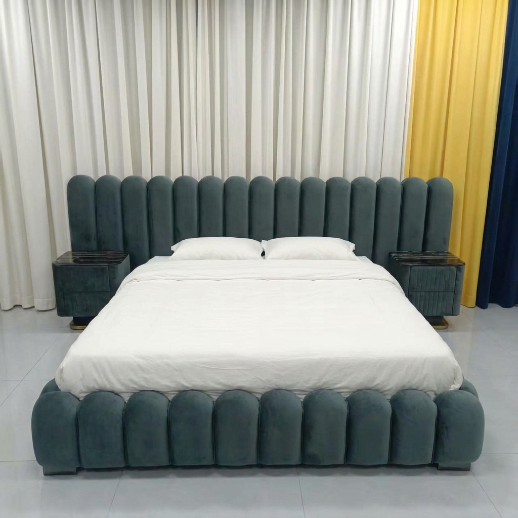 Gray upholstered bed with white bedding against a curtain backdrop