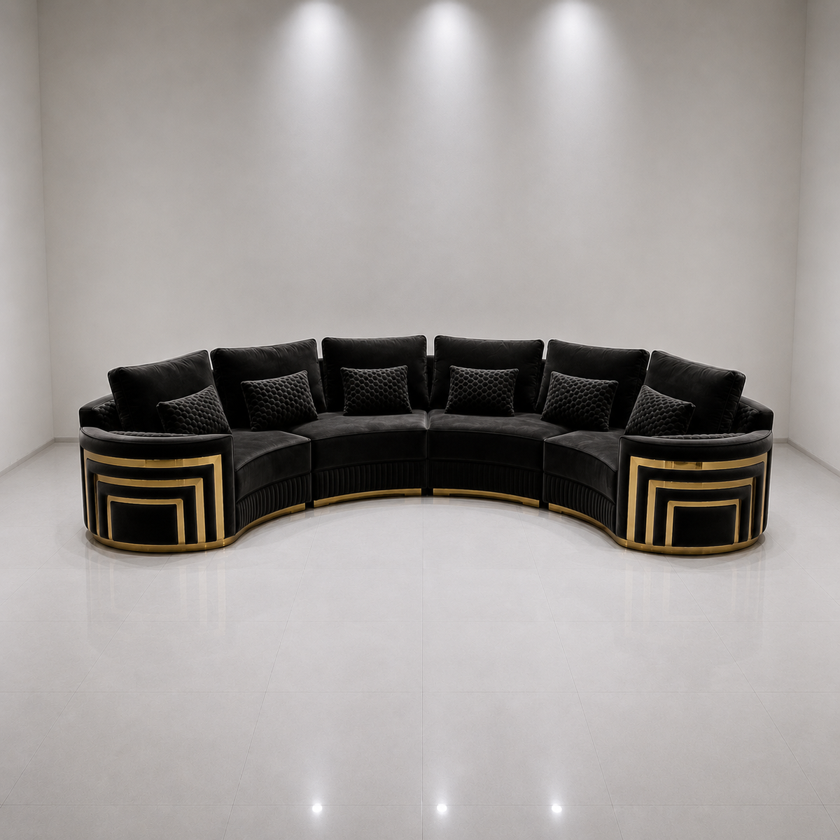 A curved modular sectional sofa upholstered in black velvet with geometric gold metal trim and matching accent pillows, set against a minimalist white studio background.