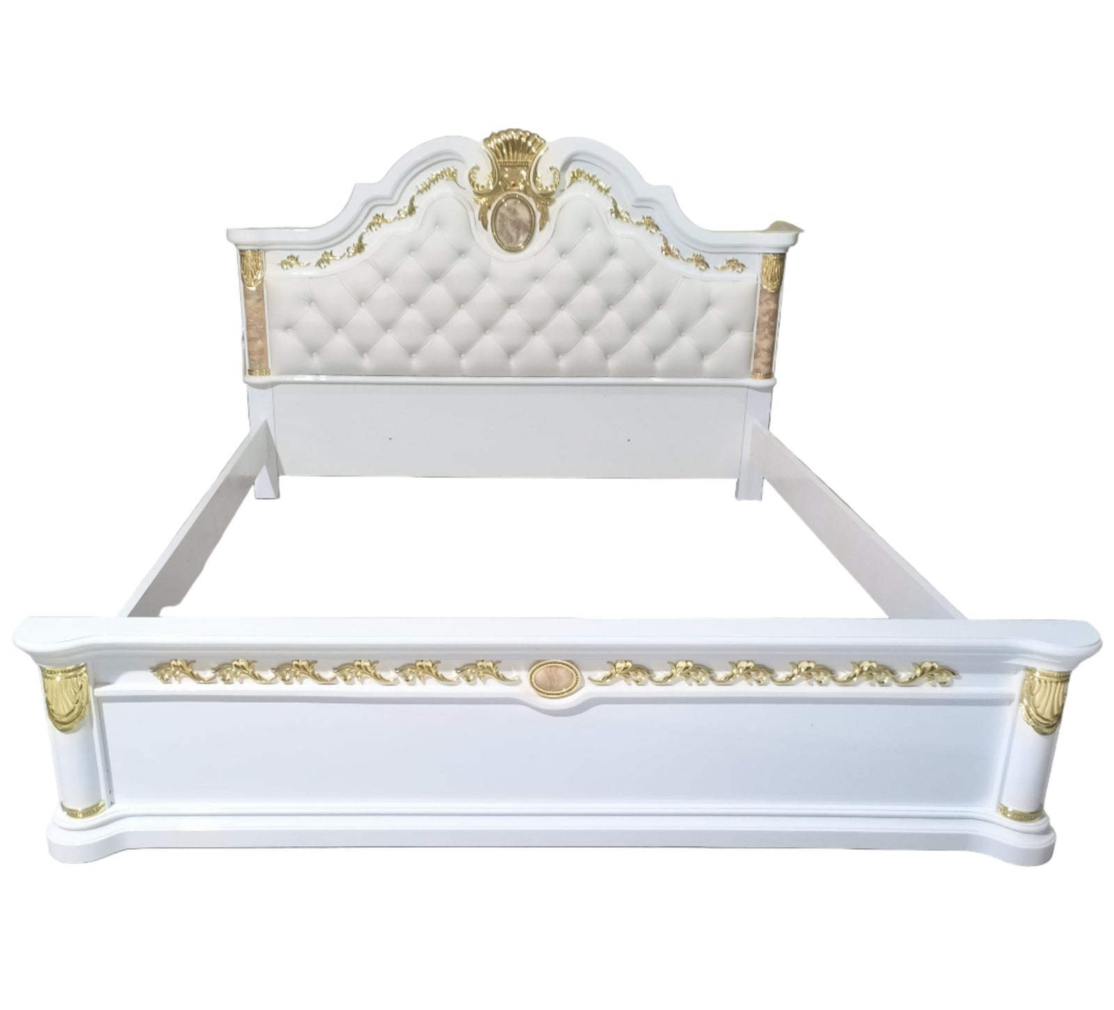 Decorative white bed with gold accents in a storage or warehouse setting.