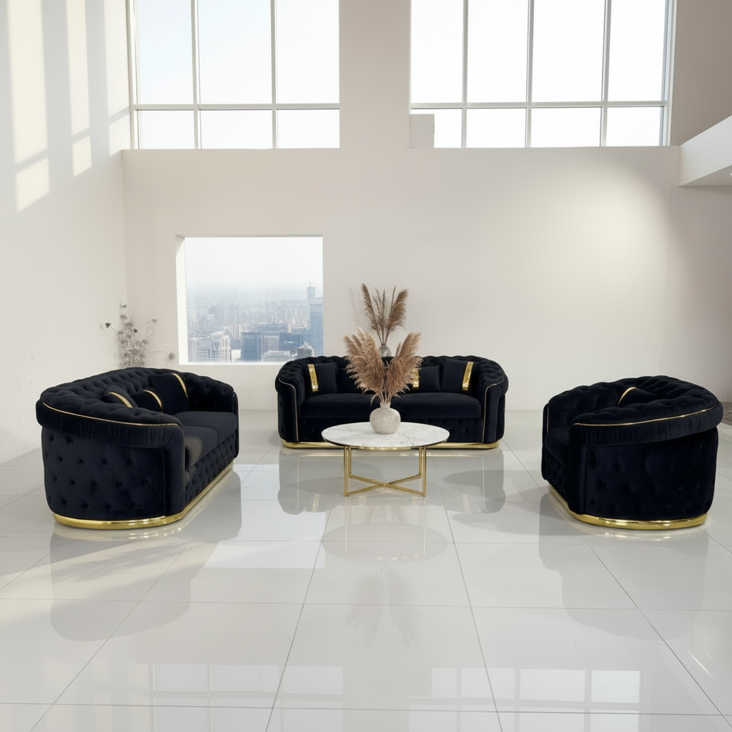 Set of black velvet sofas with gold accents on a white floor.