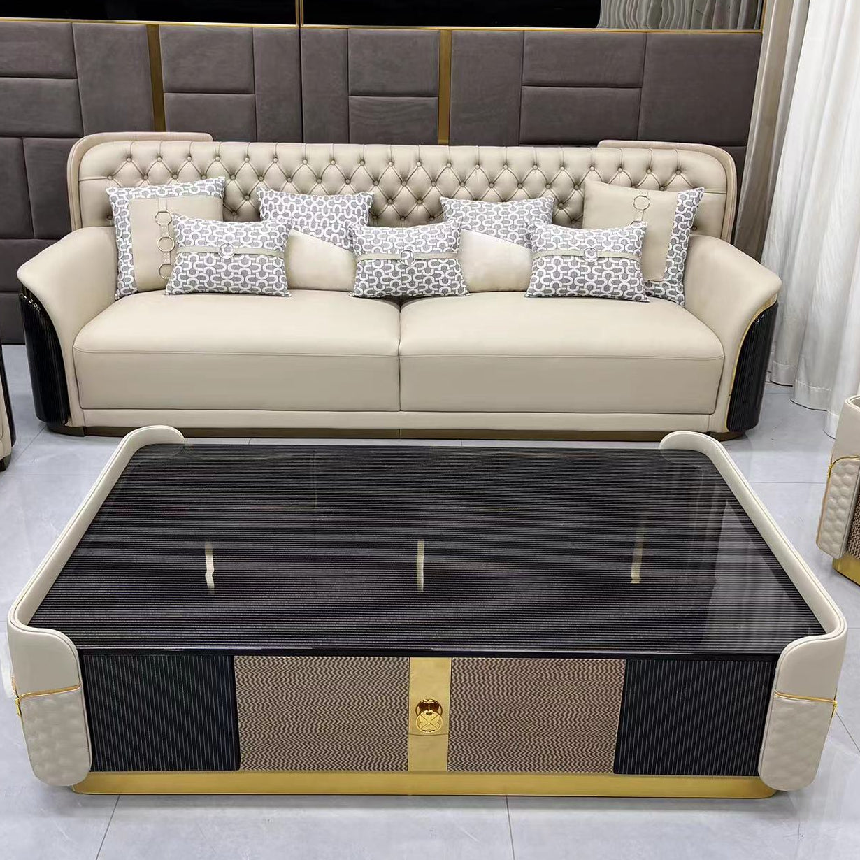 Beige sofa with decorative pillows and a glass-top coffee table in a modern living room.