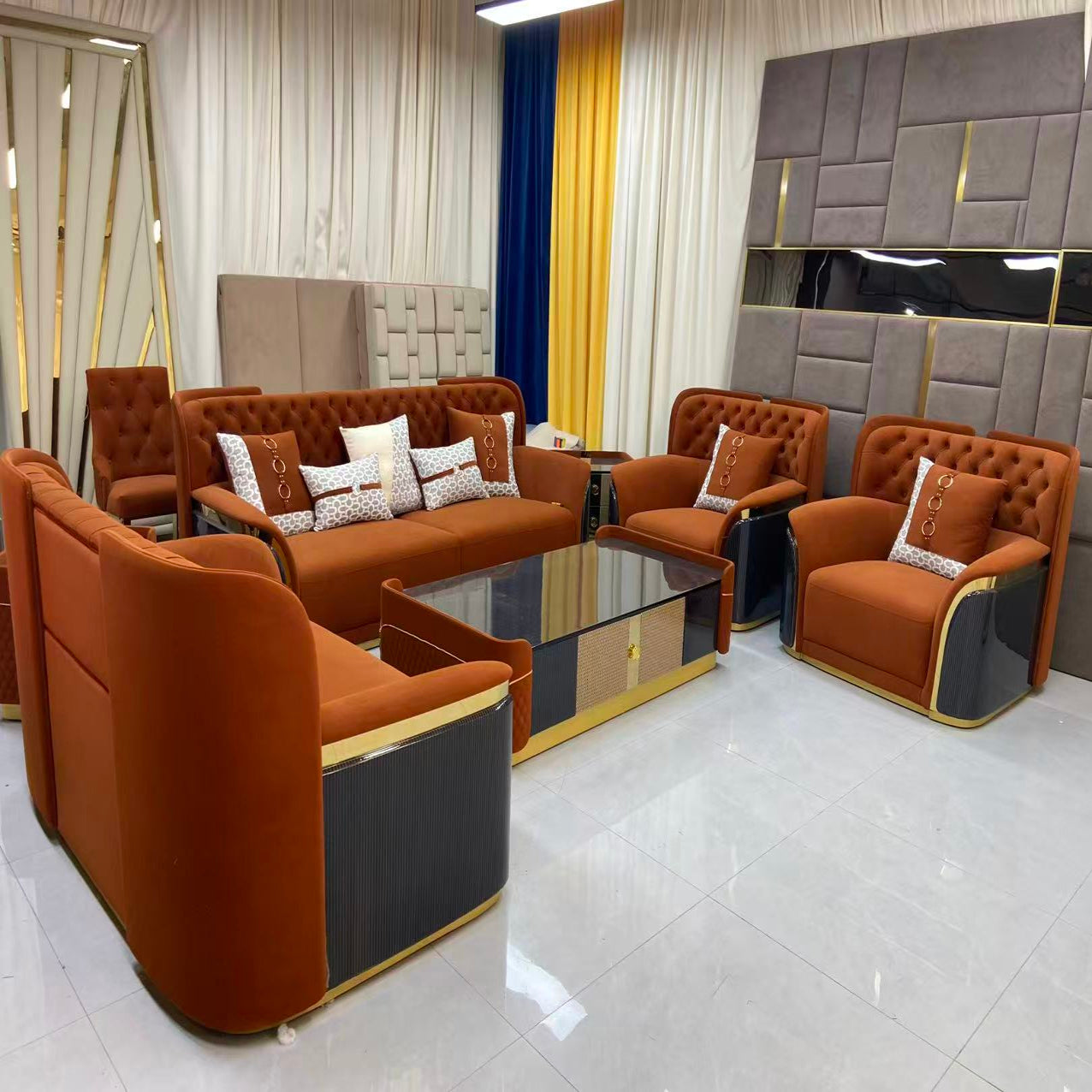 Modern living room with brown leather furniture and decorative pillows.