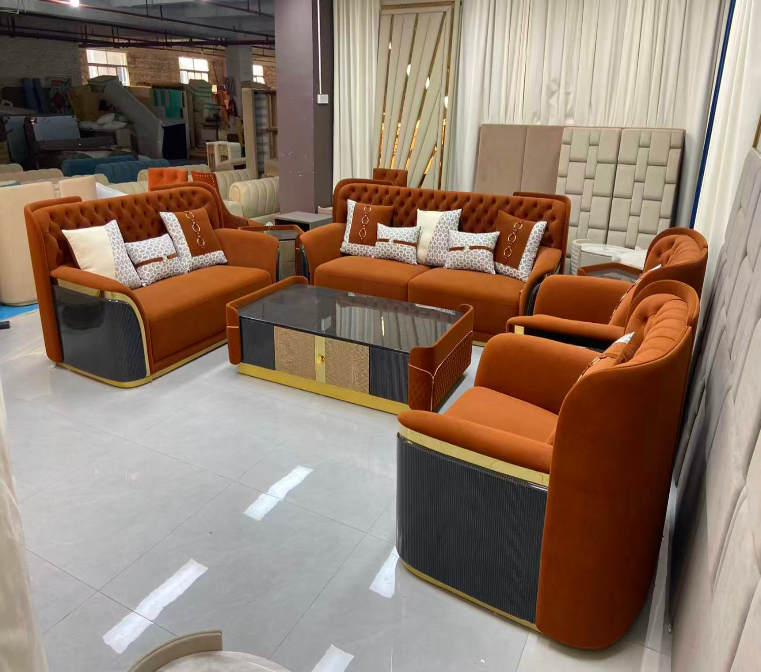 Brown sofa set with decorative pillows in a showroom setting