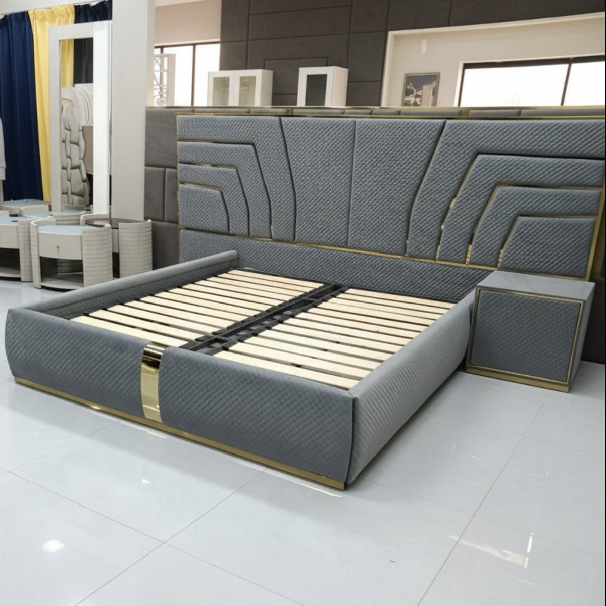 Modern gray bed with geometric headboard design on a tiled floor.