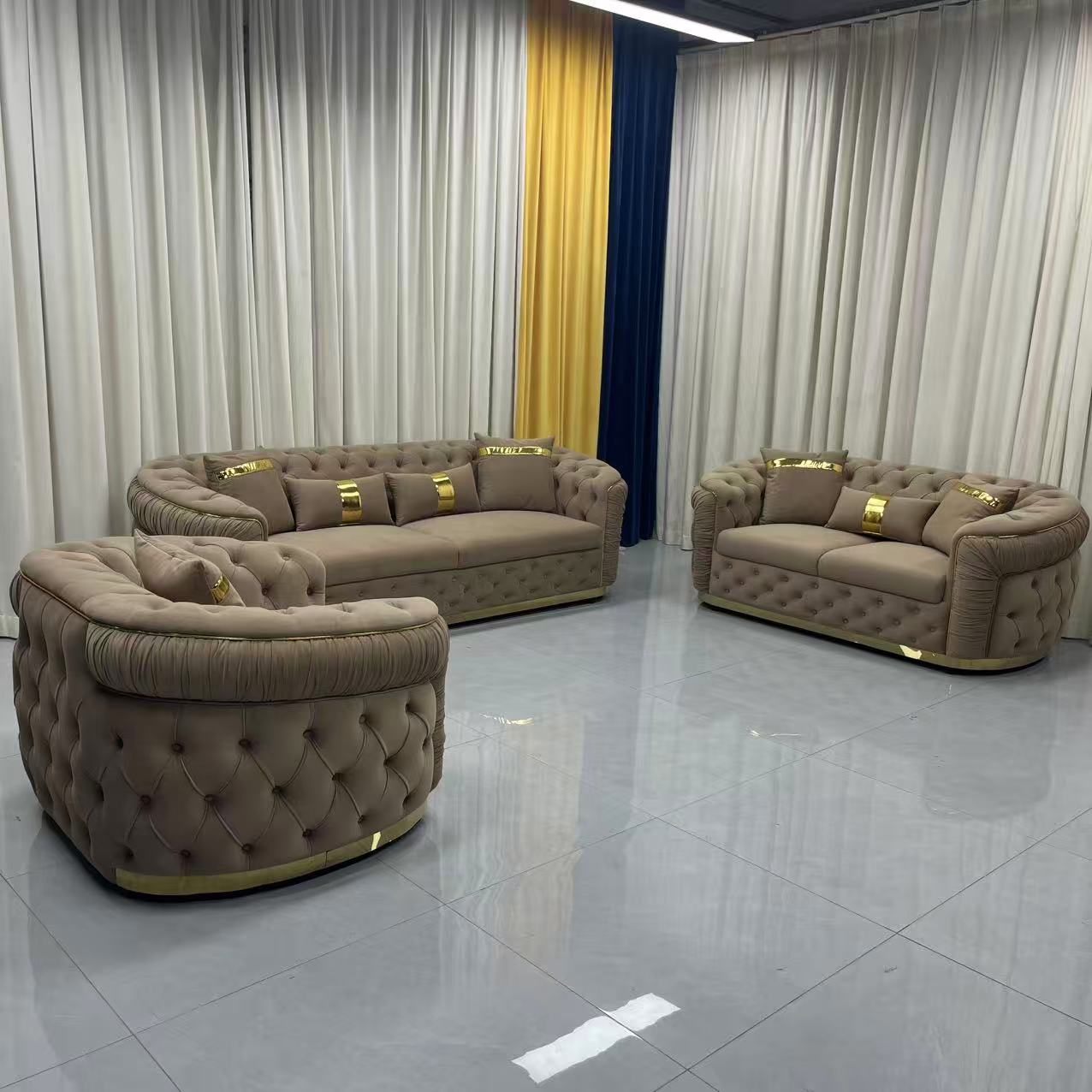 Luxury brown sofa set in a room with yellow curtains and decorative wall.