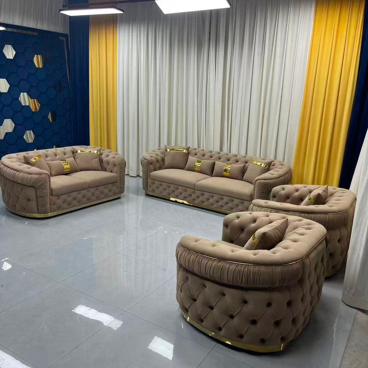 Luxury brown sofa set in a room with yellow curtains and decorative wall.