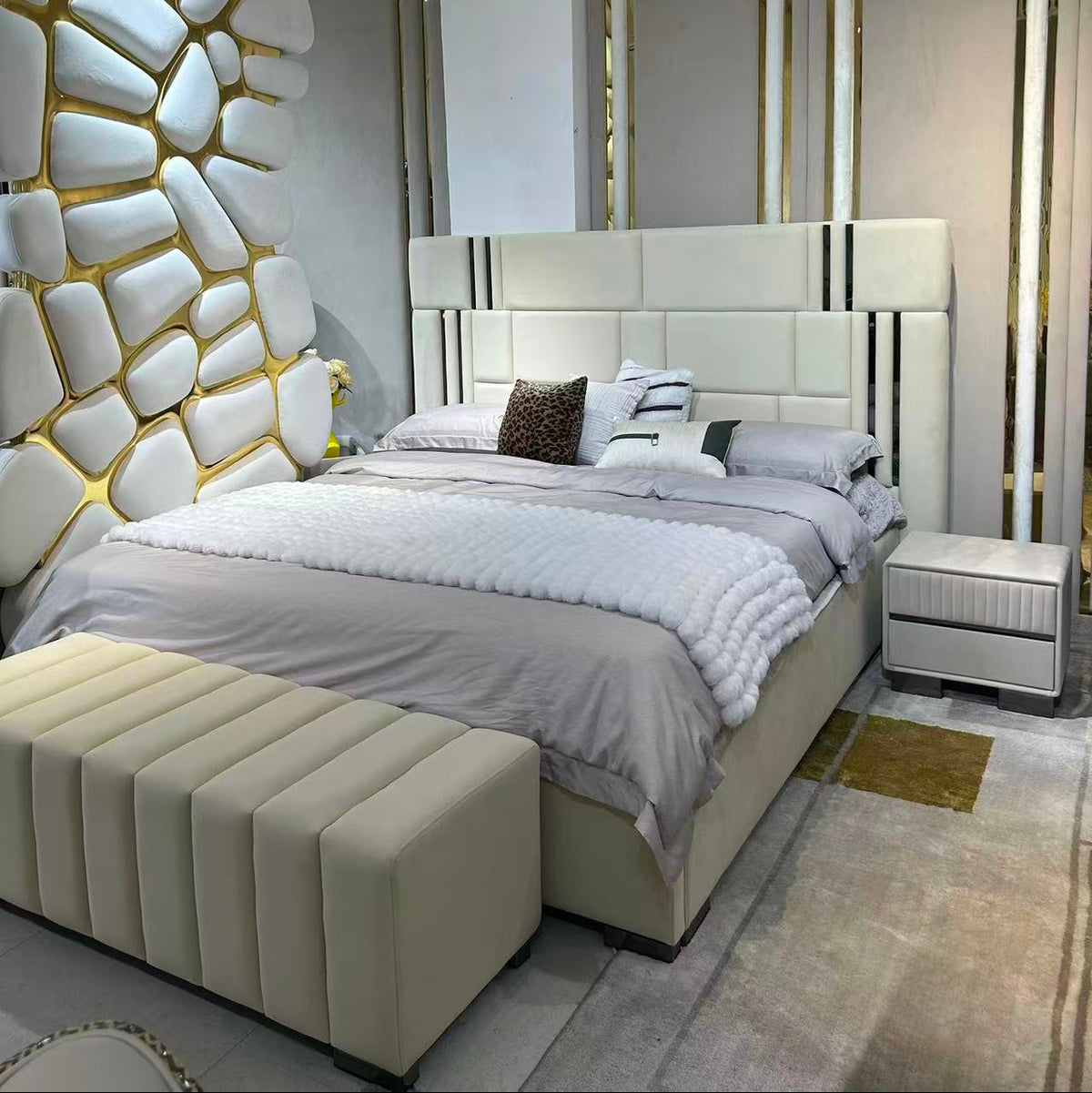 Modern bedroom with a bed, nightstands, and decorative wall.