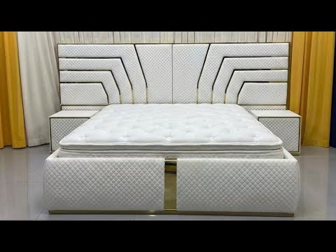 White bed with a white leather decorative headboard and 2 side tables at RBM Classic Home