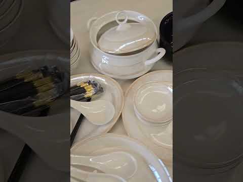 Pure Ceramic at RBM Classic Home. Stacked white dishes including bowls, plates, and cups on a light gray surface.