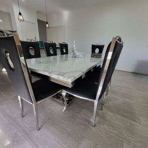 Luxurious and Stylish Elegant Marble Audi 4 Circles Dining Table with Silver Black Leather Dining Room Chairs in Silver Stainless Steel Frame.