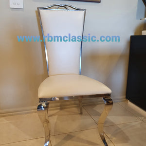 Classy Marble Dining Table With Classic White Leather Style Dining Room Chairs in Silver Stainless Steel Frame