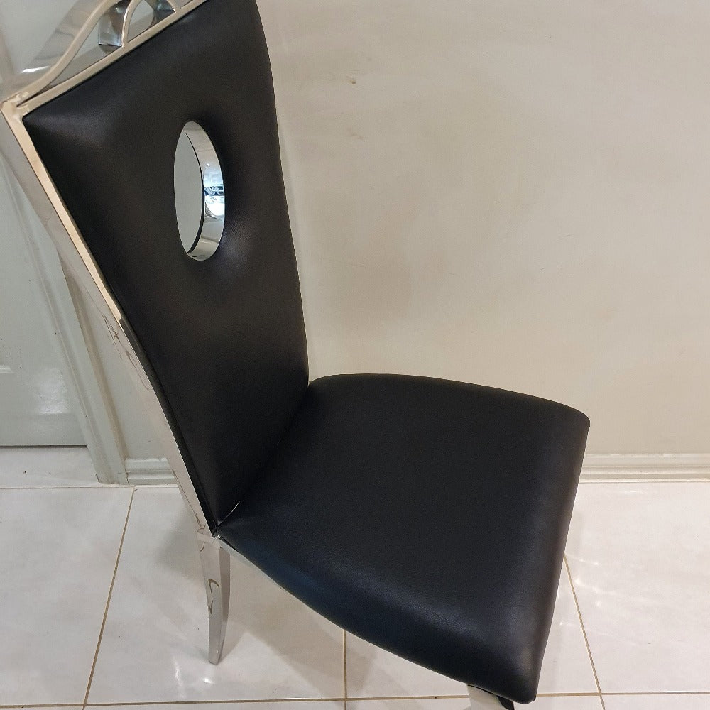 Marble Dining Table With Black Leather Dining Room Chairs in Silver Stainless Steel Frame