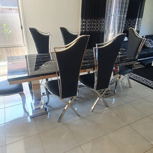 Classic Marble Dining Table With Classy Black Leather Dining Room Chairs in Silver Stainless Steel Frame